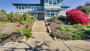 A two-story house with a front porch and a yellow door. - Sip, Shop & Explore: San Diego Apartment (San Diego)