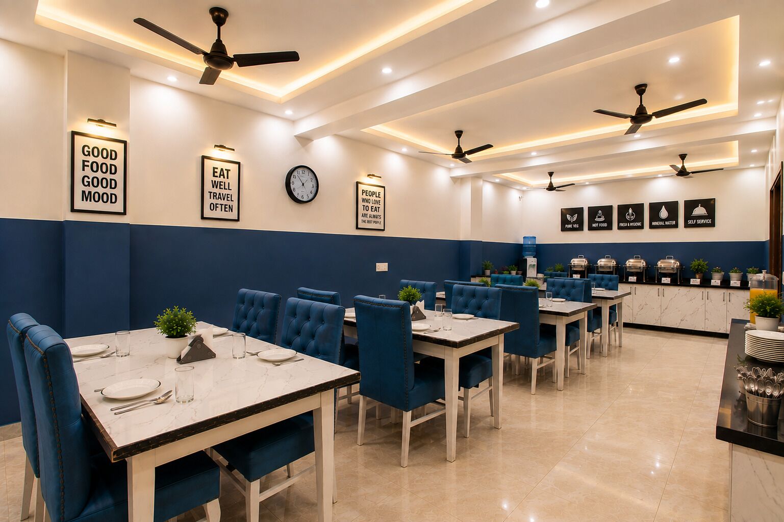 A restaurant with multiple dining tables and chairs, ceiling fans, and wall-mounted signs.