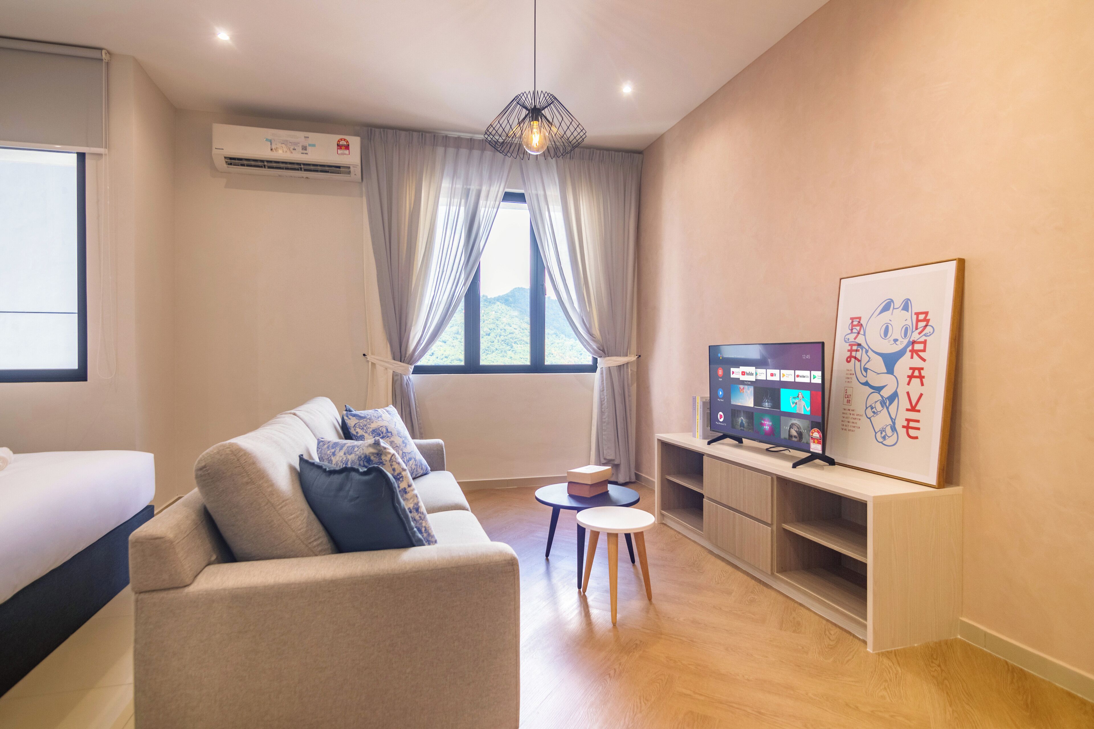 A modern living room with a sofa, a TV, and a small table.