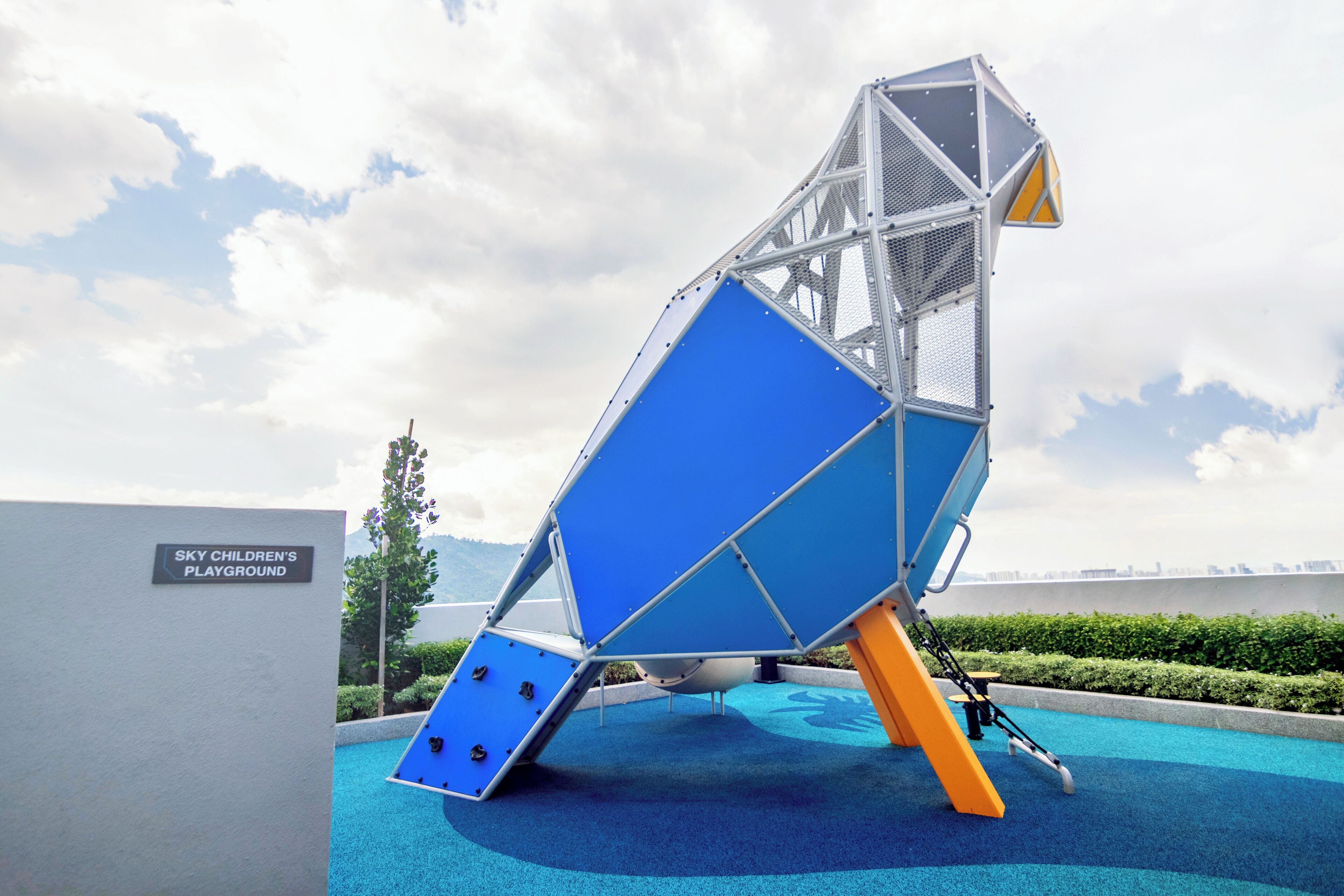 A playground structure with a sign reading "Sky Children's Playground".