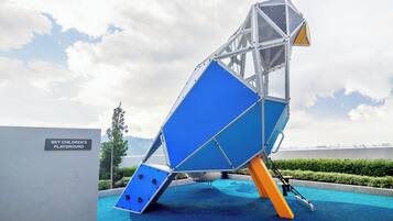 A playground structure with a sign reading "Sky Children's Playground".