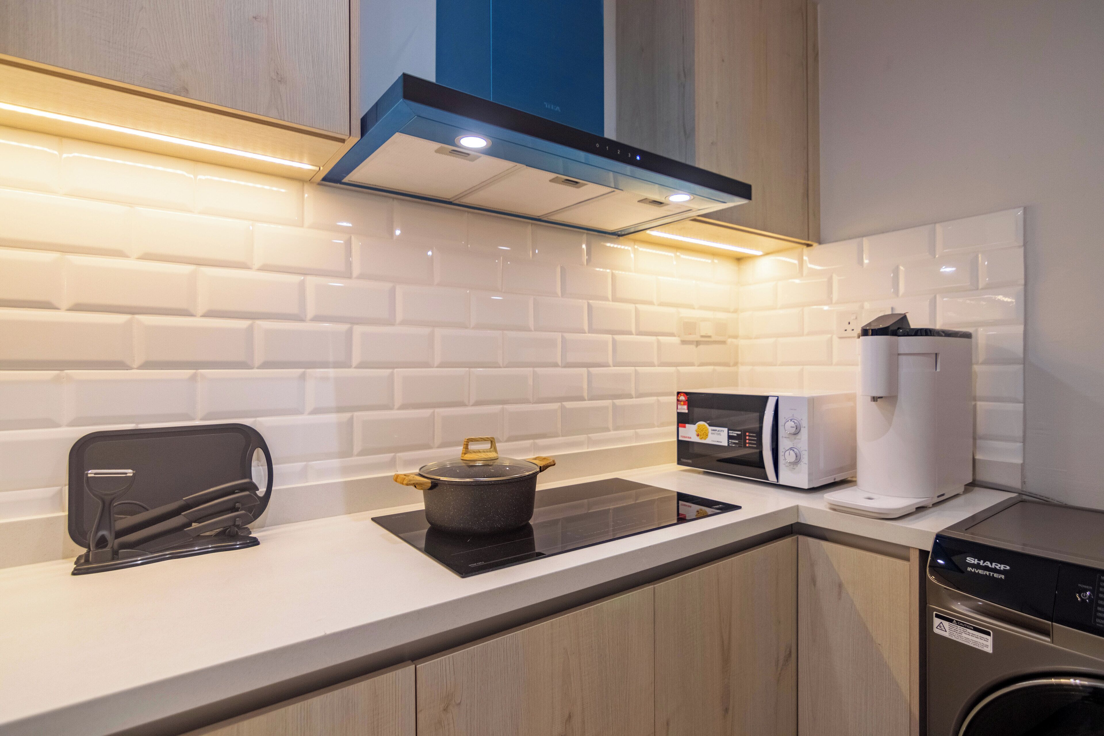 A modern kitchen with a built-in stove, microwave, and dishwasher.