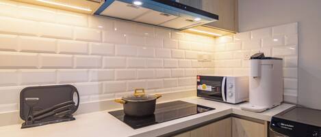 A modern kitchen with a built-in stove, microwave, and dishwasher.