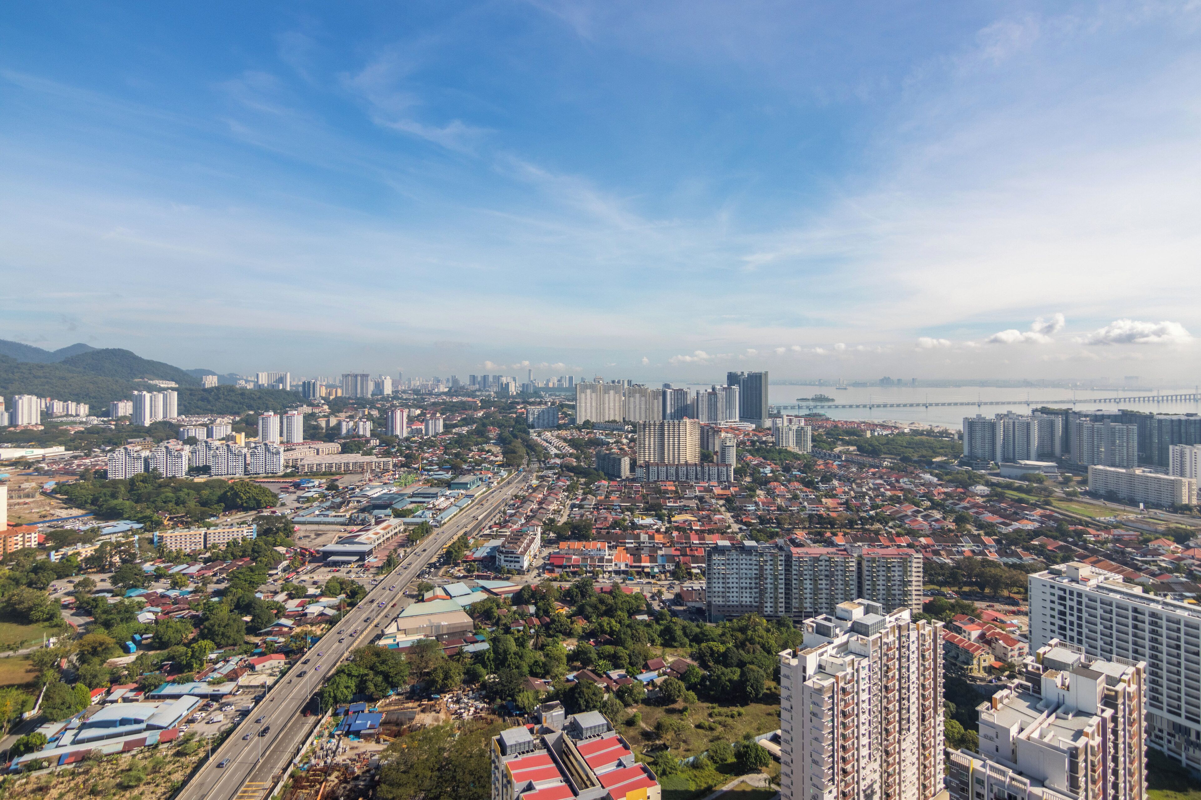 A cityscape with high-rise buildings, a bridge, and a highway.