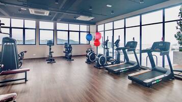 A gym with treadmills, stationary bikes, and weight machines.