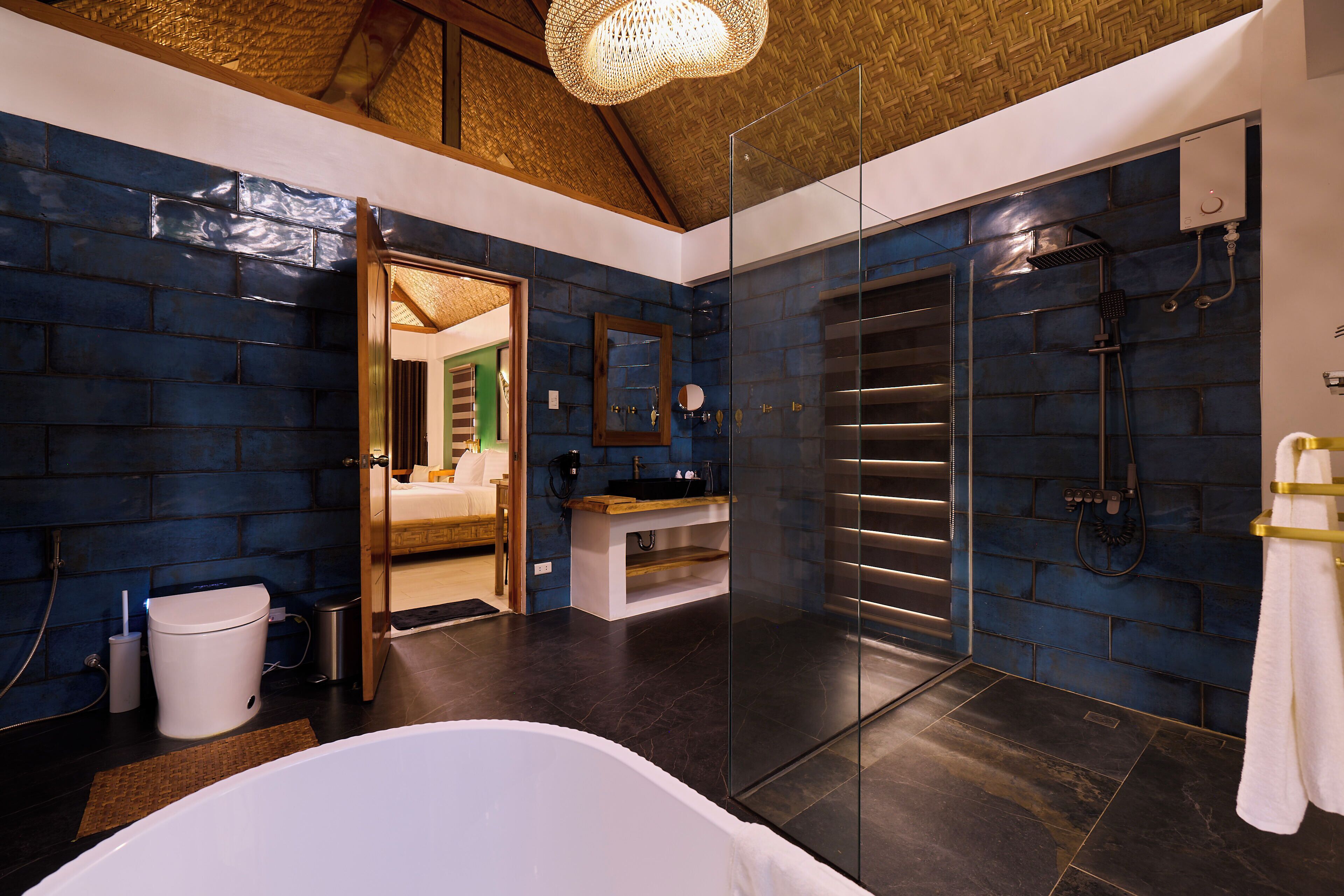 A modern bathroom with a glass shower enclosure, a white bathtub, and a wooden vanity.