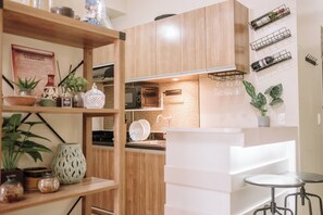 Fridge, microwave, stovetop, cookware/dishes/utensils - Playful & Charming City Loft (Iloilo City)