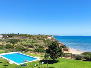 A pool with a clear view of the ocean and a beach in the background. - Villa LUZ 552 in Conil de la Frontera (Conil de la Frontera)