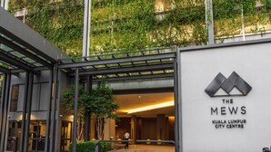 The entrance to The Mews Kuala Lumpur City Centre with a modern design, glass doors, and a sign indicating the location. - The Mews KLCC by Five Senses (Kuala Lumpur)