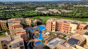 A resort with multiple swimming pools, a golf course, and a view of the surrounding landscape. - The Prime at The Residences Vilamoura (Loulé)