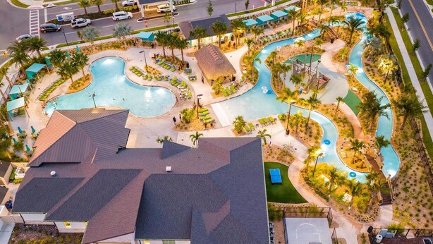 An aerial view of a resort with a large swimming pool, a water slide, and a tennis court. - Storey Lake Resort, Private Pool, Near Famous Attractions!! (Kissimmee)