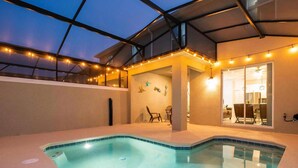 A swimming pool with a glass ceiling, string lights, and a dining area with chairs and tables. - Storey Lake Resort, Private Pool, Near Famous Attractions!! (Kissimmee)