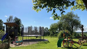 A playground with a climbing wall, slide, and swings. - Holiday apartment in beautiful natural surroundings with the whole family in the immediate vicinity of Ulm. (Neu-Ulm)