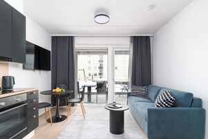 Luxury Studio Suite, Garden View | Living area | TV