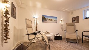 A room with a wooden floor, a white desk, a chair, a large mirror, and a picture on the wall. - Bright 3-room holiday apartment on approx. 100 m² for up to 4 people (Westerland)