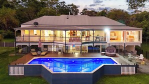 A large house with a swimming pool, multiple decks, and outdoor furniture. - Paddock View Ranch in the Sunny Coast Countryside (Belli Park)