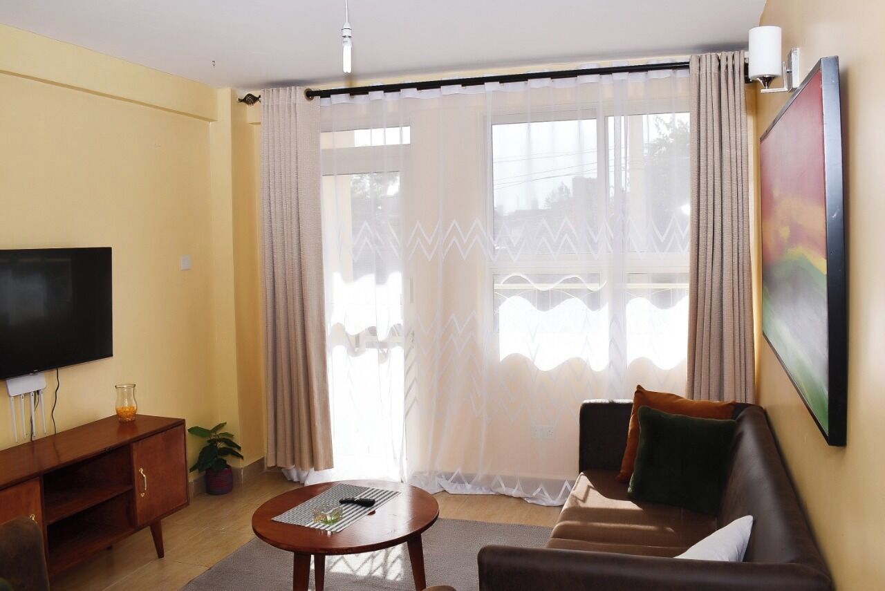 Comfort Apartment, City View | Living area | 32-inch Smart TV with digital channels