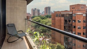 Ein Balkon mit Blick auf umliegende Gebäude und Bäume.