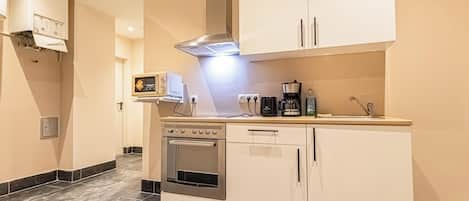 Basic Room, 1 King Bed, Non Smoking, City View | Private kitchen | Fridge, microwave, oven, stovetop