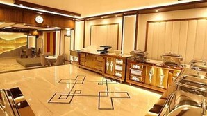 A spacious lobby with a marble floor, a reception desk, and a seating area. - LAVIT HOTEL (Faridabad)