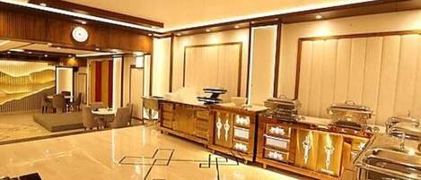 A spacious lobby with a marble floor, a reception desk, and a seating area.