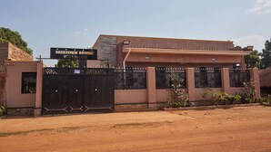 A gated building with a sign reading "Freetown Resort." - Freetown Resort-Gulu (Gulu)