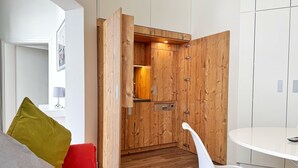 A modern kitchen with wooden cabinetry and a built-in oven. - Comfort apartment Wabi Sabi in the Villa Glückspilz for 4 people, beach location (Binz)