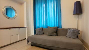 Comfort Quadruple Room | Living area | 32-inch flat-screen TV with cable channels