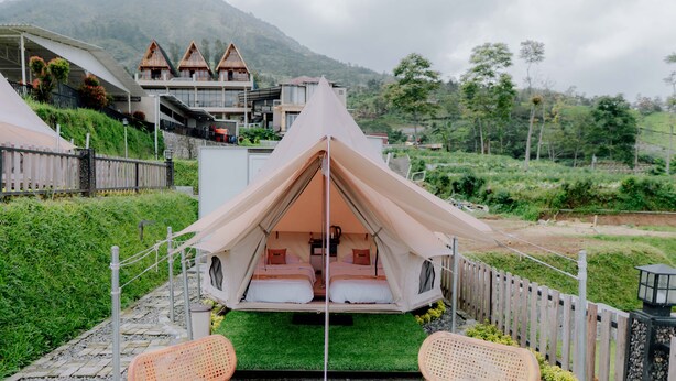 A tented accommodation with a view of a mountain, a wooden fence, and a pathway leading to it. - Glamping Telaga Menjer By Travelink (Garung)
