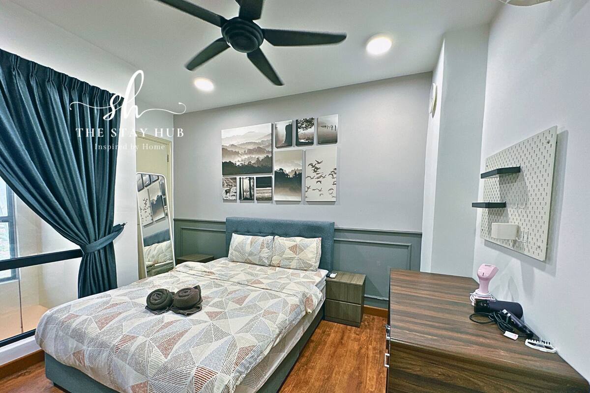 A modern bedroom with a bed, a ceiling fan, a bedside table, a nightstand, a dresser, and a wall-mounted shelf.