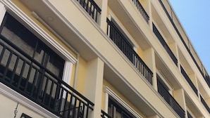 A multi-story building with balconies and large windows. - The Burapa Rooms (Bangkok)