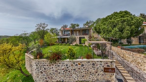 A stone-walled property with a stone staircase leading to a wooden deck. - Assosa Country House (Ayvacik)