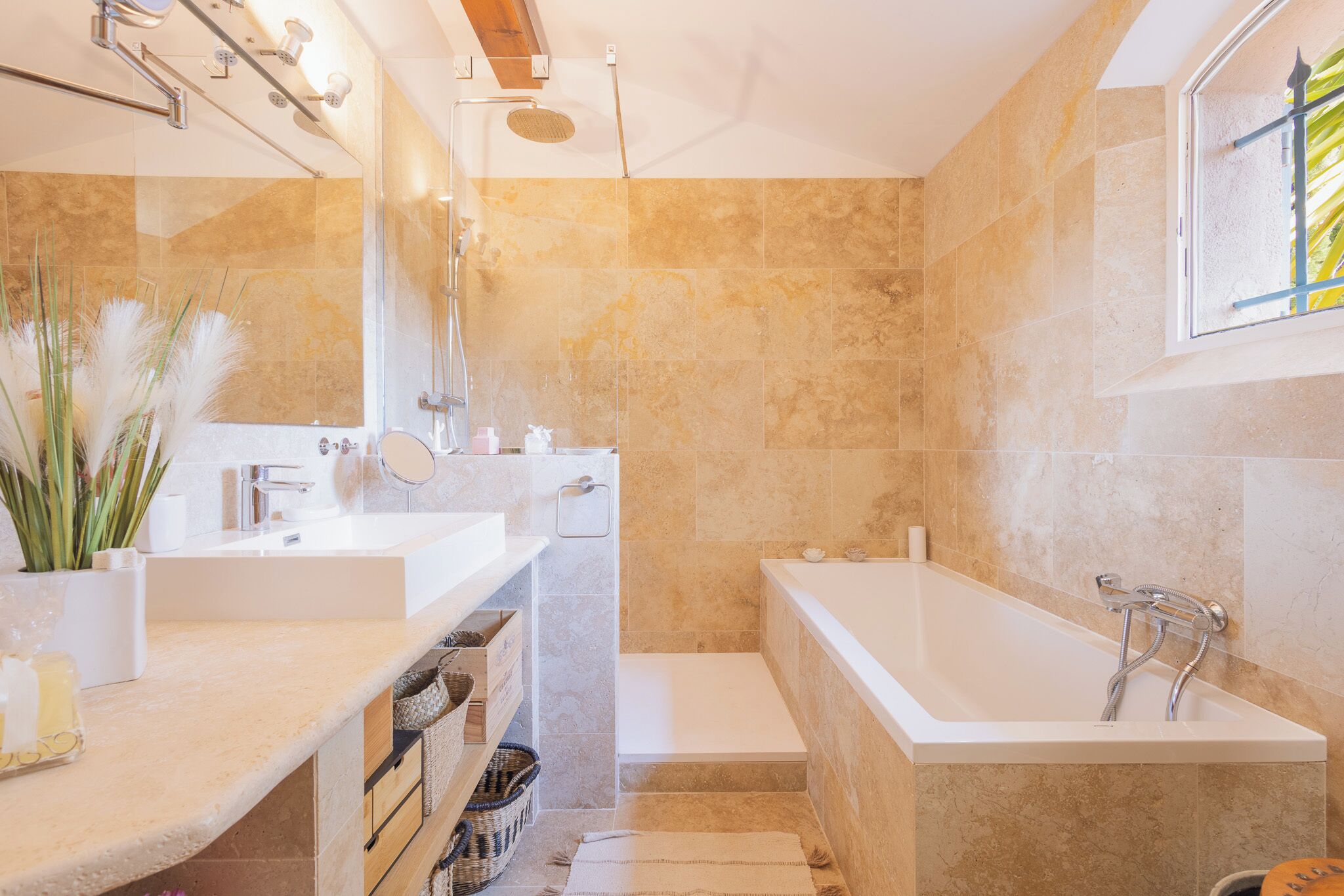 A modern bathroom with a bathtub, a shower, and a vanity with a mirror.