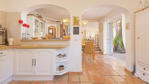 A spacious kitchen with white cabinetry, a wooden countertop, and a tiled floor. - House for 10 people with private pool in Sainte-Maxime. (Sainte-Maxime)