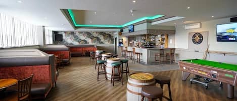 Relax in our spacious bar area with a pool table, dartboard, and comfortable seating.
