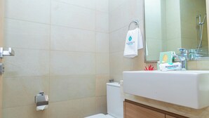 A bathroom with a white sink, a mirror, a towel hanging on a rack, and toiletries on the counter. - Bloomfields Cozy STU in Azizi Riviera (Dubai)