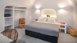 A modern bedroom with a large bed, built-in shelving, and a unique curved ceiling design.