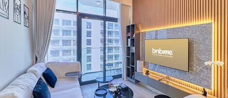 Premium Apartment, 1 Queen Bed, Balcony, Pool View | Living room | 55-inch Smart TV with cable channels