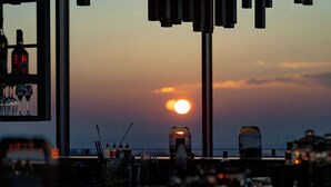 A sunset view from a bar area with bottles and glasses on shelves. - Wald.Weit Rheingau Hotel und Retreat (Kiedrich)
