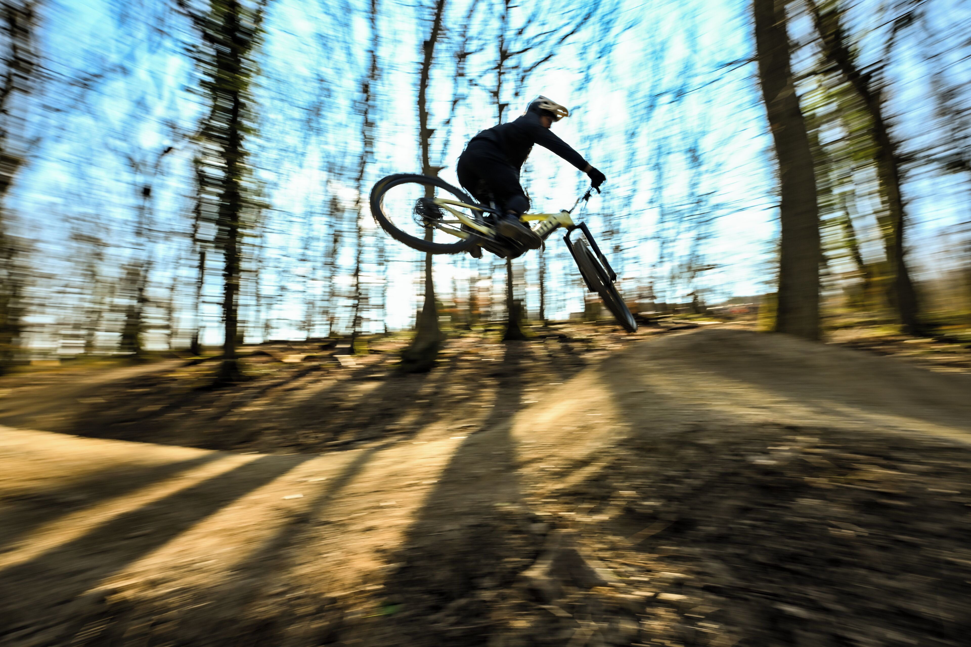 A person on a mountain bike in a forested area.