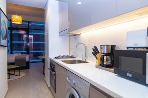 A modern kitchen with a built-in oven, a dishwasher, and a coffee maker.