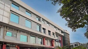 A multi-story building with a modern architectural style, featuring a prominent sign with the name 'OYO'. - HOTEL O ONE HOTEL (Ghaziabad)