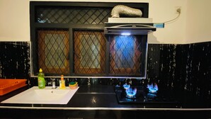 A kitchen with a black countertop, a white sink, and a window with a metal grill. - 2-bedroom house in nice Pilimathalwa with WiFi, AC (Pilimathalwa)