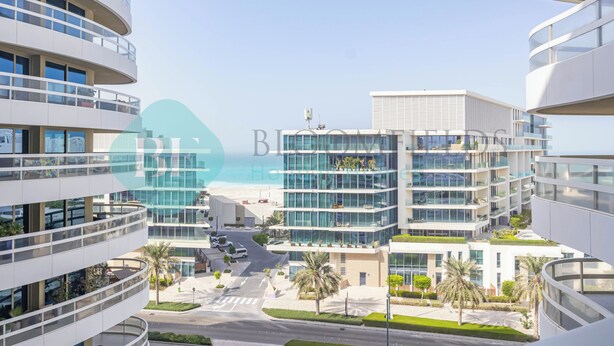 A modern multi-story hotel with balconies, a central courtyard, and a view of the beach. - Bloomfields 2BR Soul Beach in Saadiyat (Abu Dhabi)