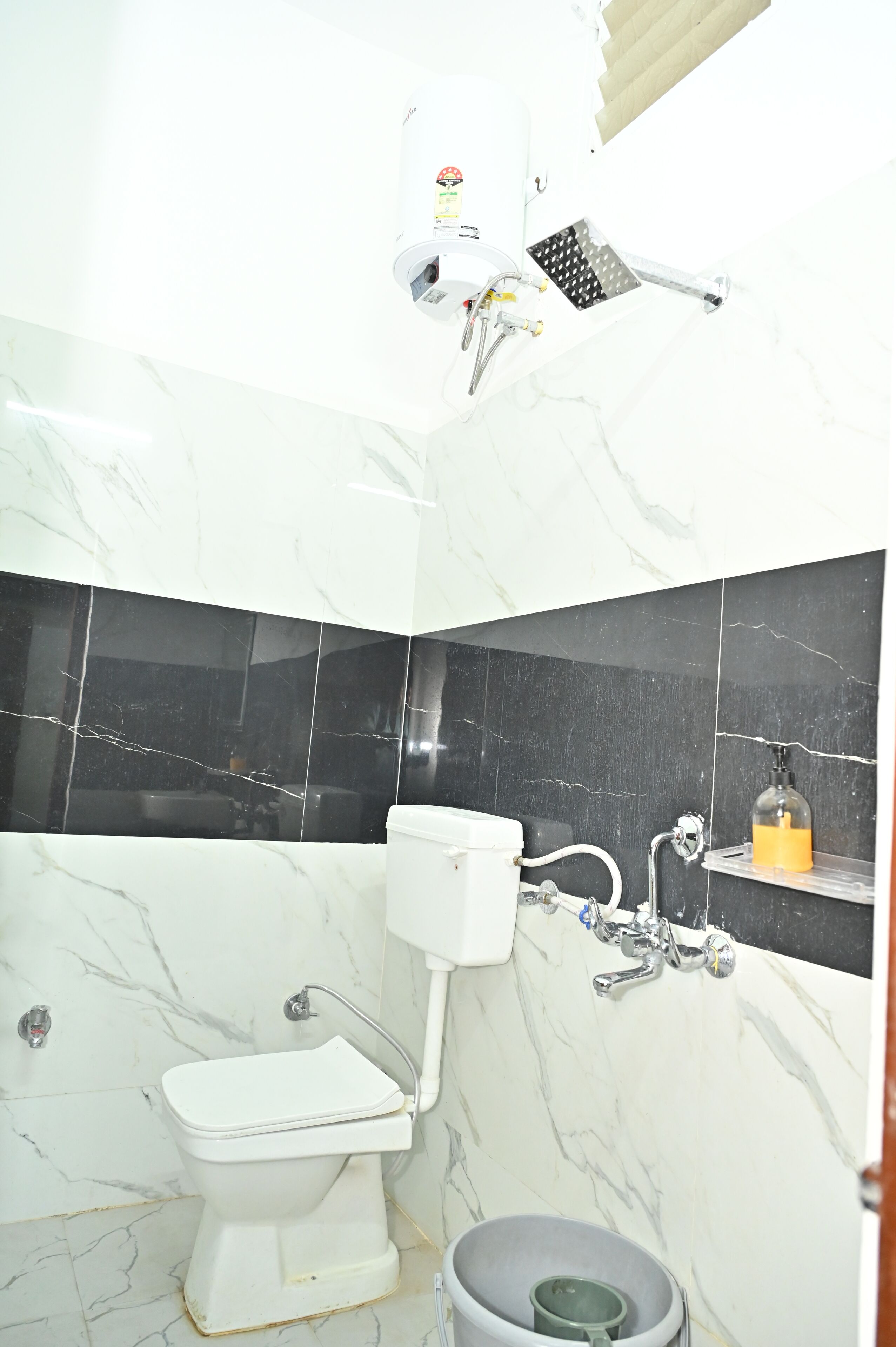 A bathroom with a toilet, a bidet, a shower, and a sink.