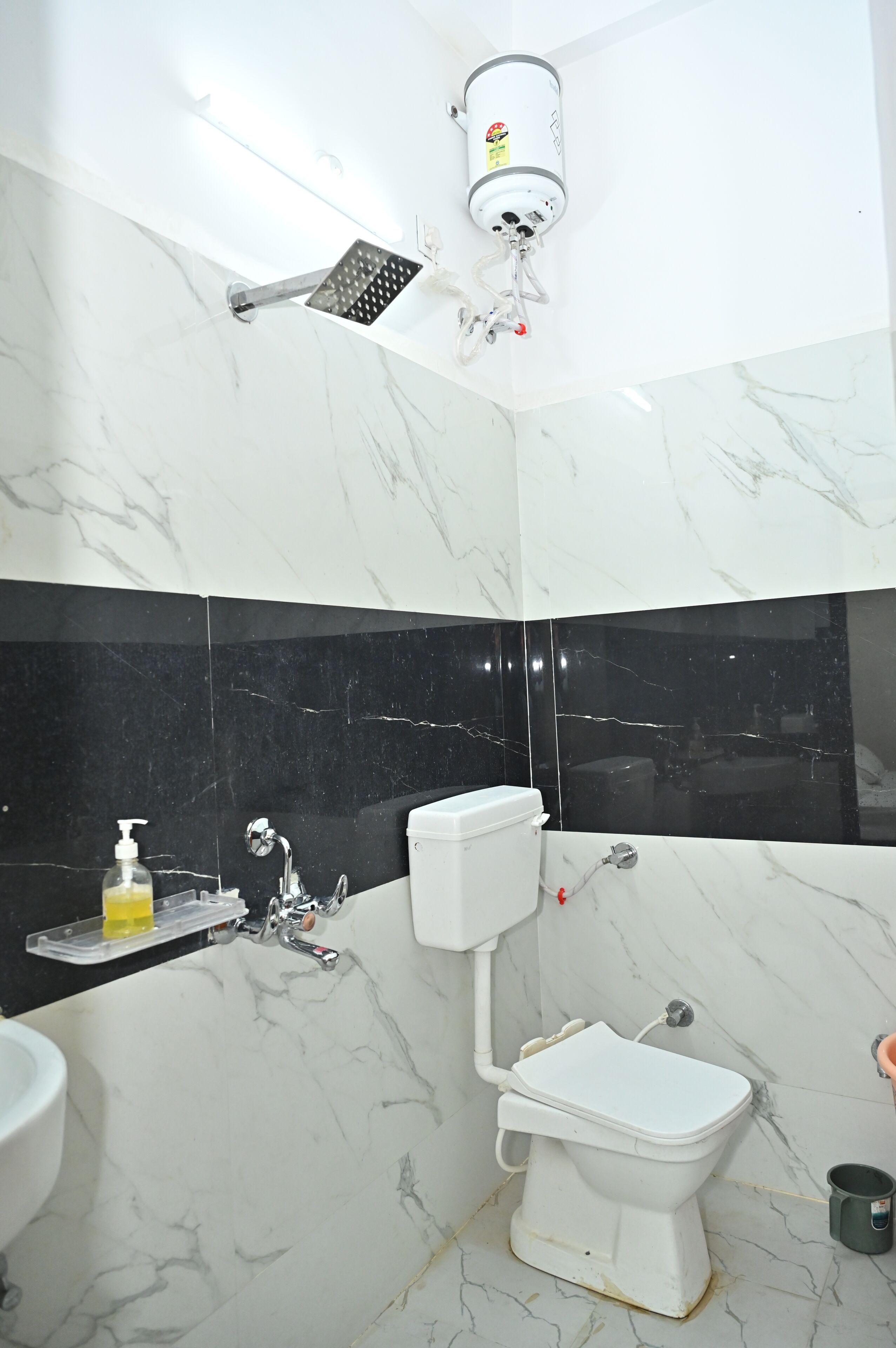 A bathroom with a toilet, sink, and shower.
