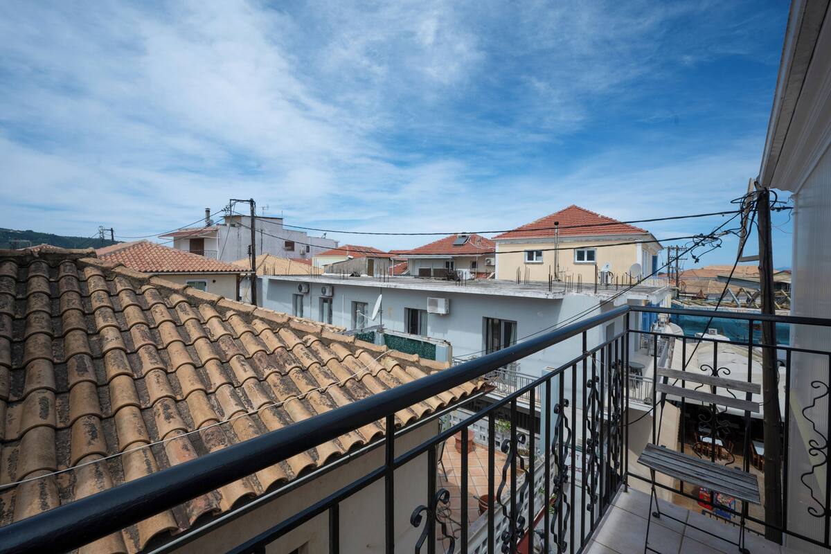 A residential area with terracotta-tiled roofs and balconies.