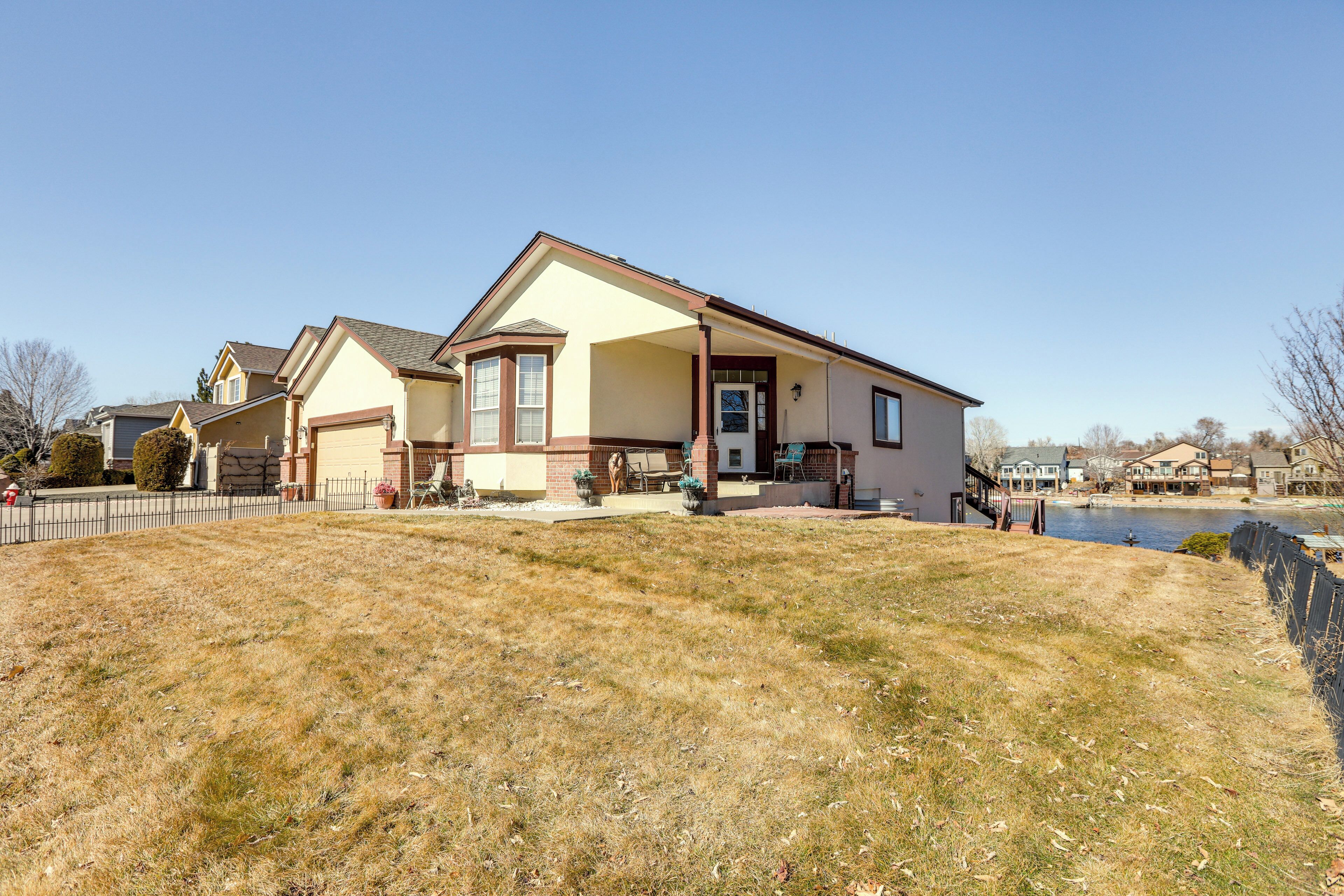 A two-story house with a garage, a front porch, and a small front yard.