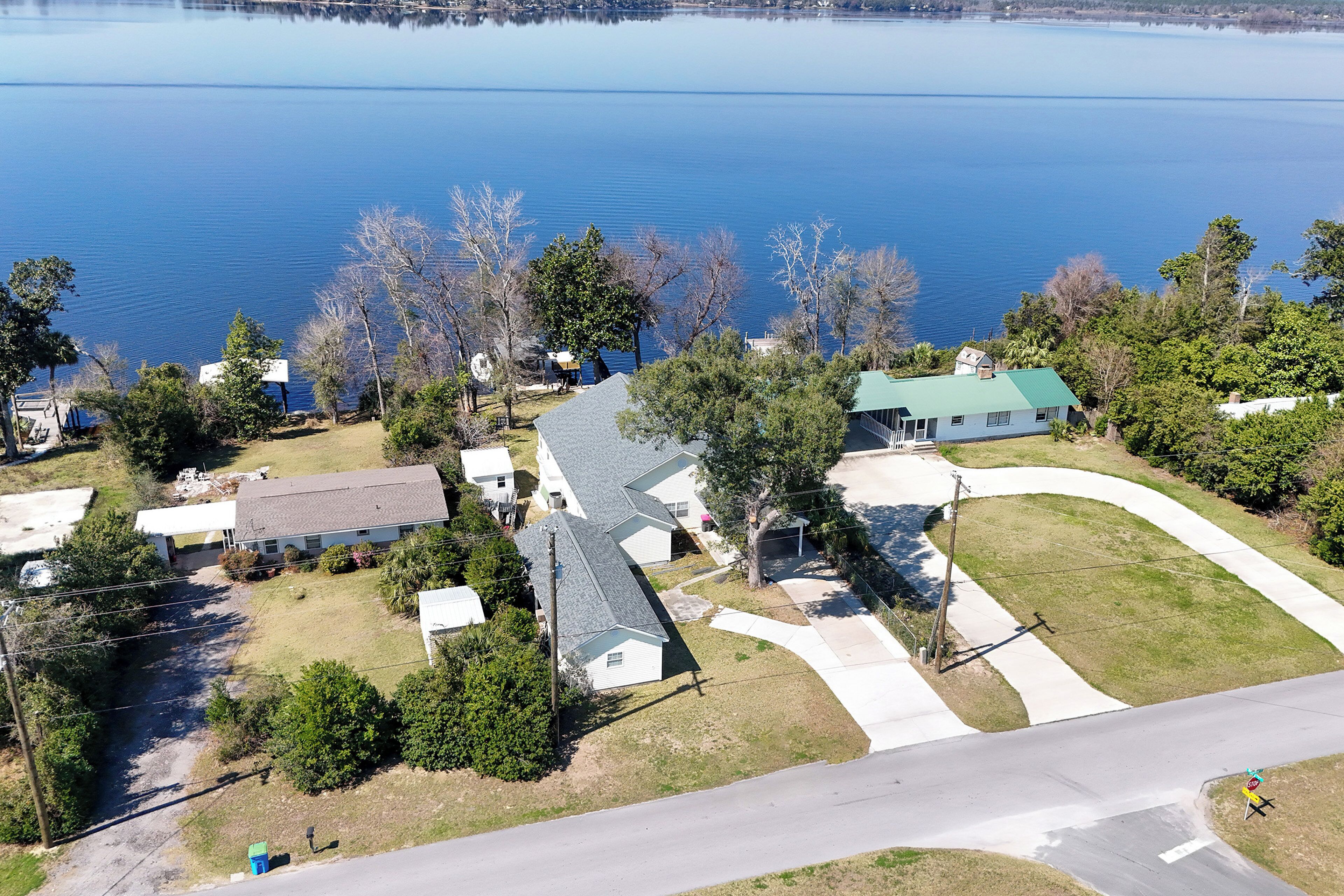 A residential area with houses, a lake, and a road.