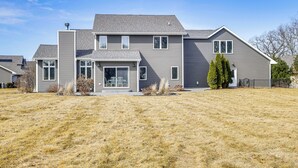 A two-story house with a large front yard, a covered entryway, and a garage. - 8 Mi to Lambeau Field: Family Home in De Pere! (De Pere)